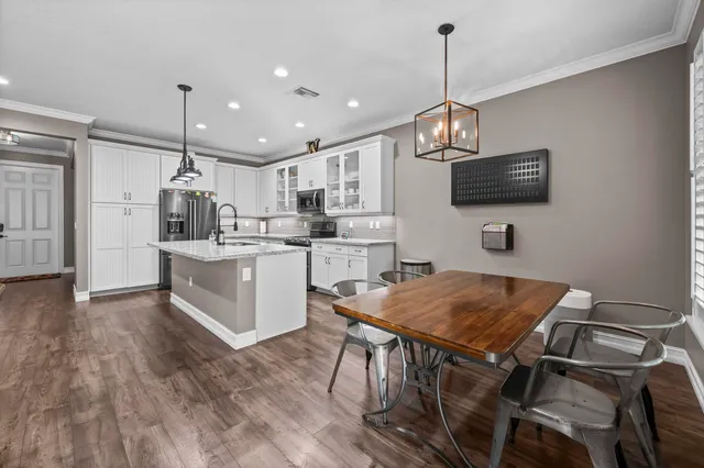 a view of a room with wooden floor and a ceiling fan