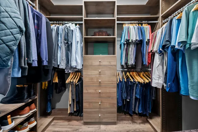 a bathroom with a granite countertop sink a mirror a vanity and a bathtub