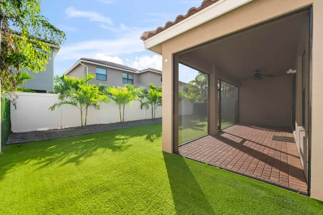 an aerial view of a house with a yard and potted plants