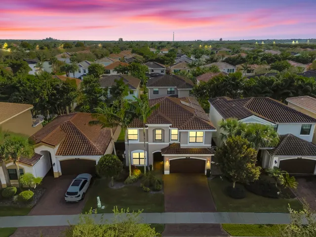 an aerial view of residential houses with outdoor space and swimming pool