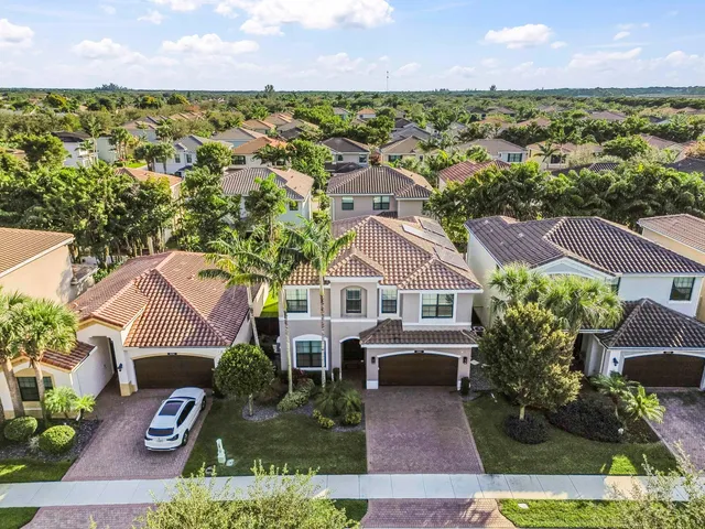 an aerial view of a house with yard swimming pool and outdoor seating