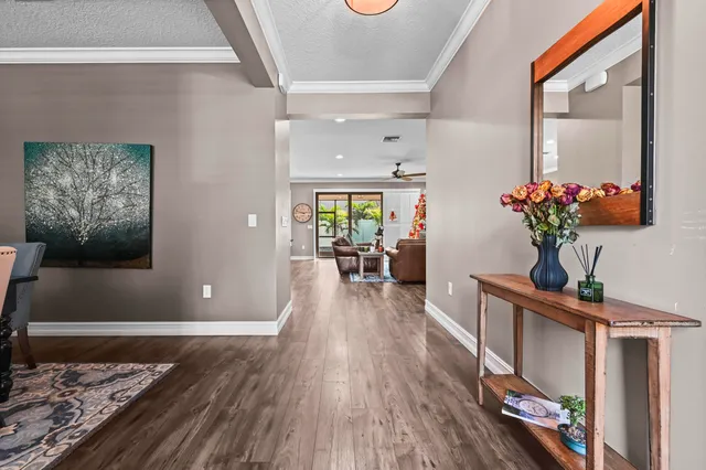 a view of a dining room with furniture wooden floor and a chandelier