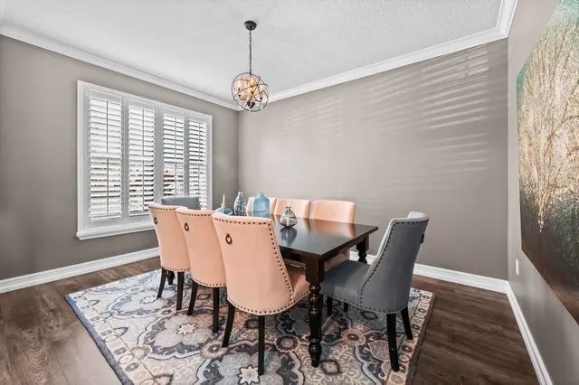 a living room with furniture large window and wooden floor