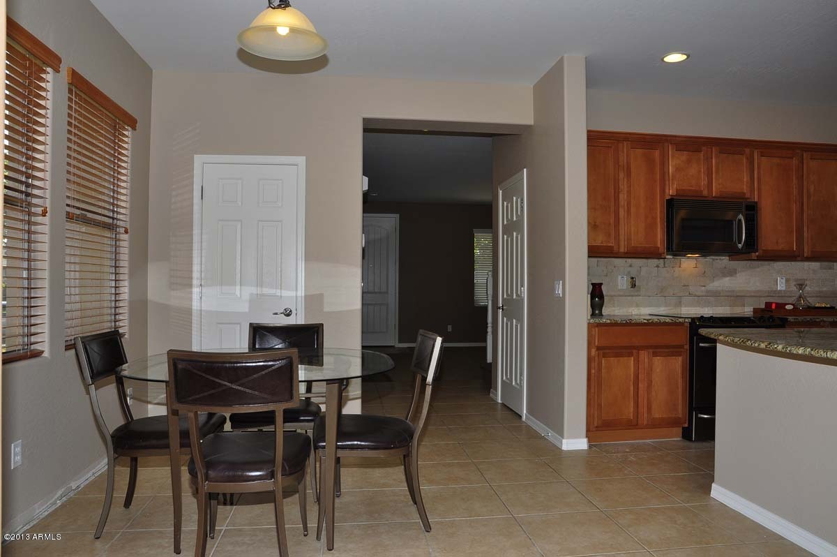 20798 West Ridge Road Buckeye, AZ 85396 - Photo 14 of 47 a view of a dining room with furniture and wooden floor