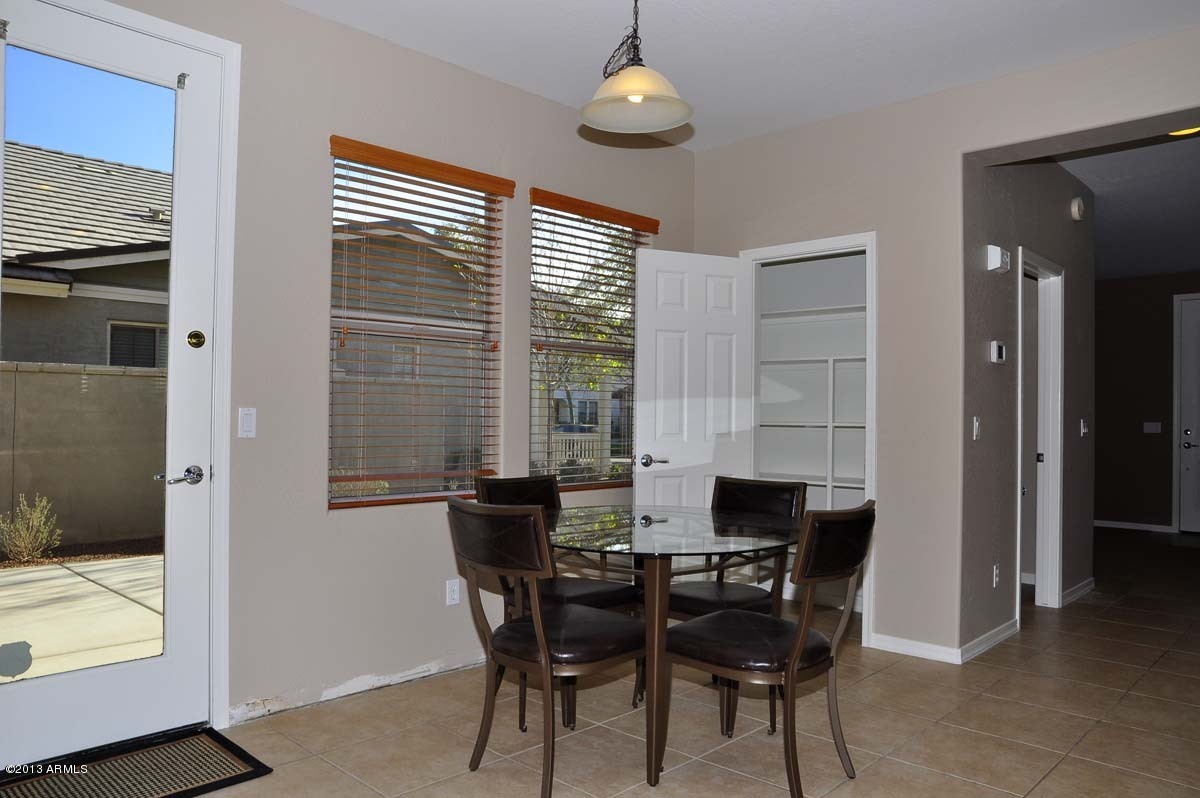 20798 West Ridge Road Buckeye, AZ 85396 - Photo 15 of 47 a view of a dining room with furniture and a window