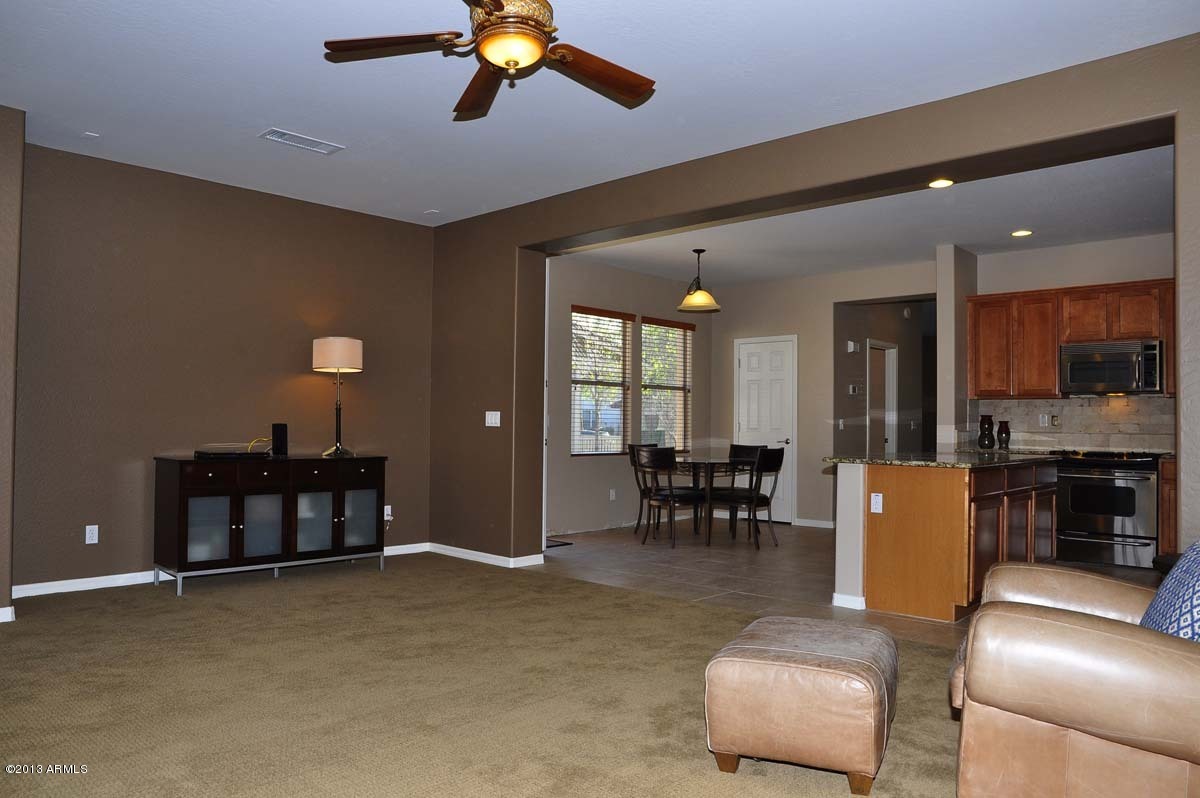 20798 West Ridge Road Buckeye, AZ 85396 - Photo 17 of 47 a living room with furniture and a dining table