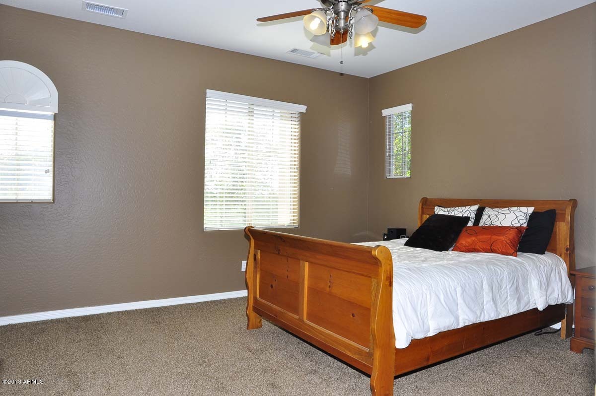 20798 West Ridge Road Buckeye, AZ 85396 - Photo 26 of 47 a bedroom with a bed and window
