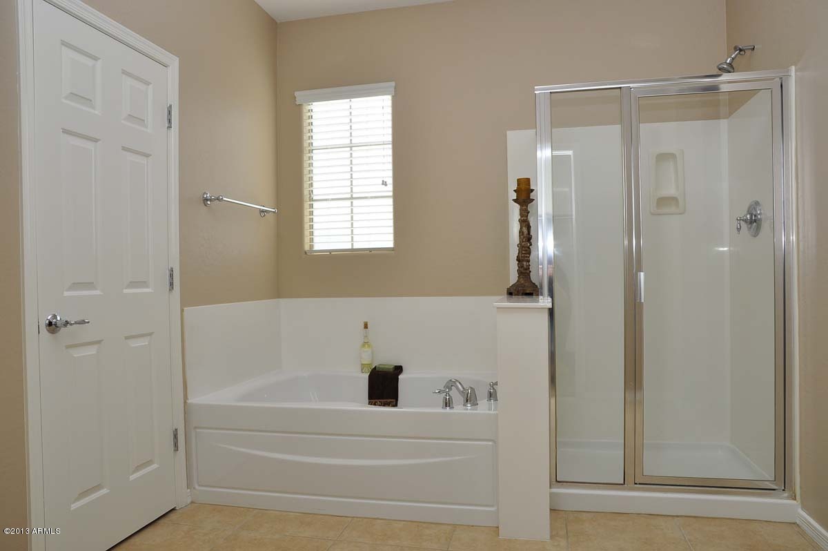 20798 West Ridge Road Buckeye, AZ 85396 - Photo 30 of 47 a bathroom with a bathtub and a shower