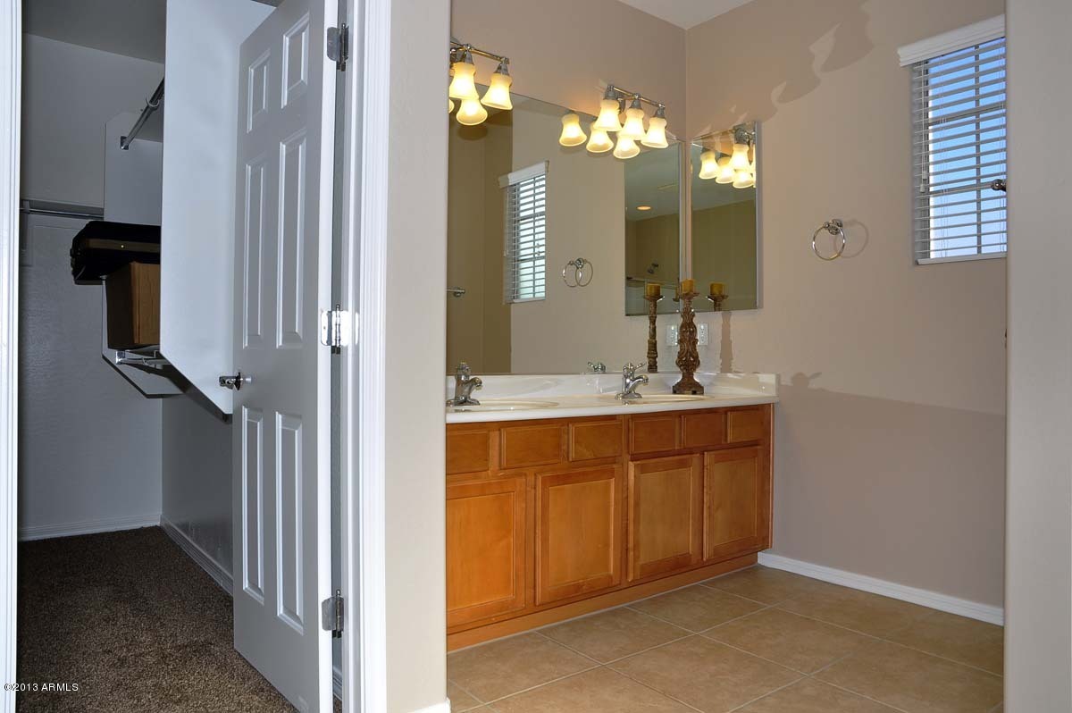 20798 West Ridge Road Buckeye, AZ 85396 - Photo 32 of 47 a bathroom with a double vanity sink and a mirror