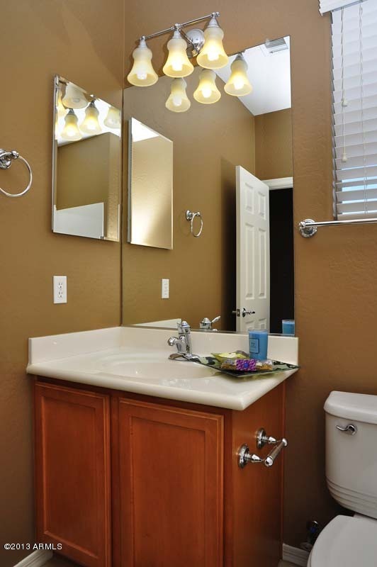 20798 West Ridge Road Buckeye, AZ 85396 - Photo 34 of 47 a bathroom with a granite countertop sink and a mirror