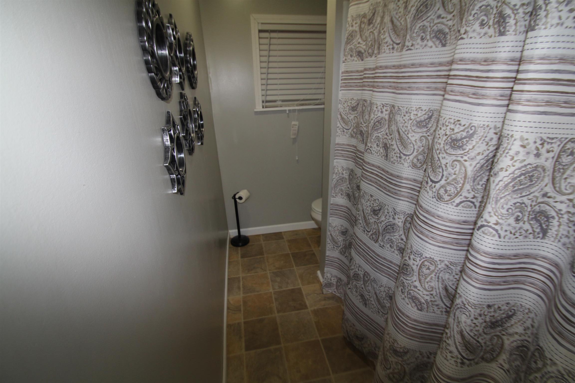1090 Lambert Ridge Road Wartrace, TN 37183 - Photo 9 of 11 a bathroom with a shower curtain