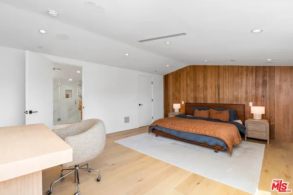 a bedroom with a bed and a couch
