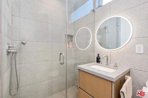 a bathroom with a sink vanity and a mirror