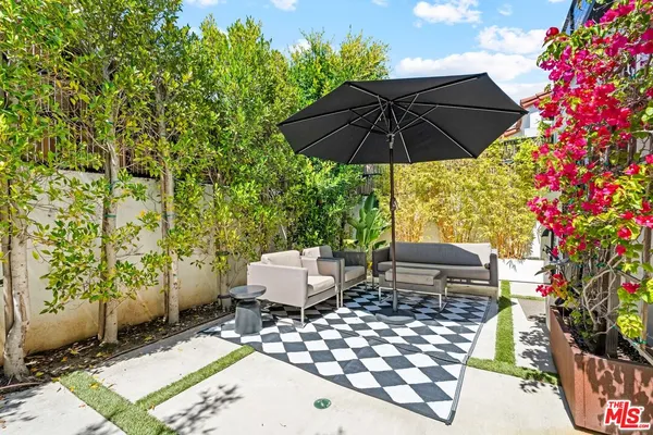 a view of backyard of house with seating space