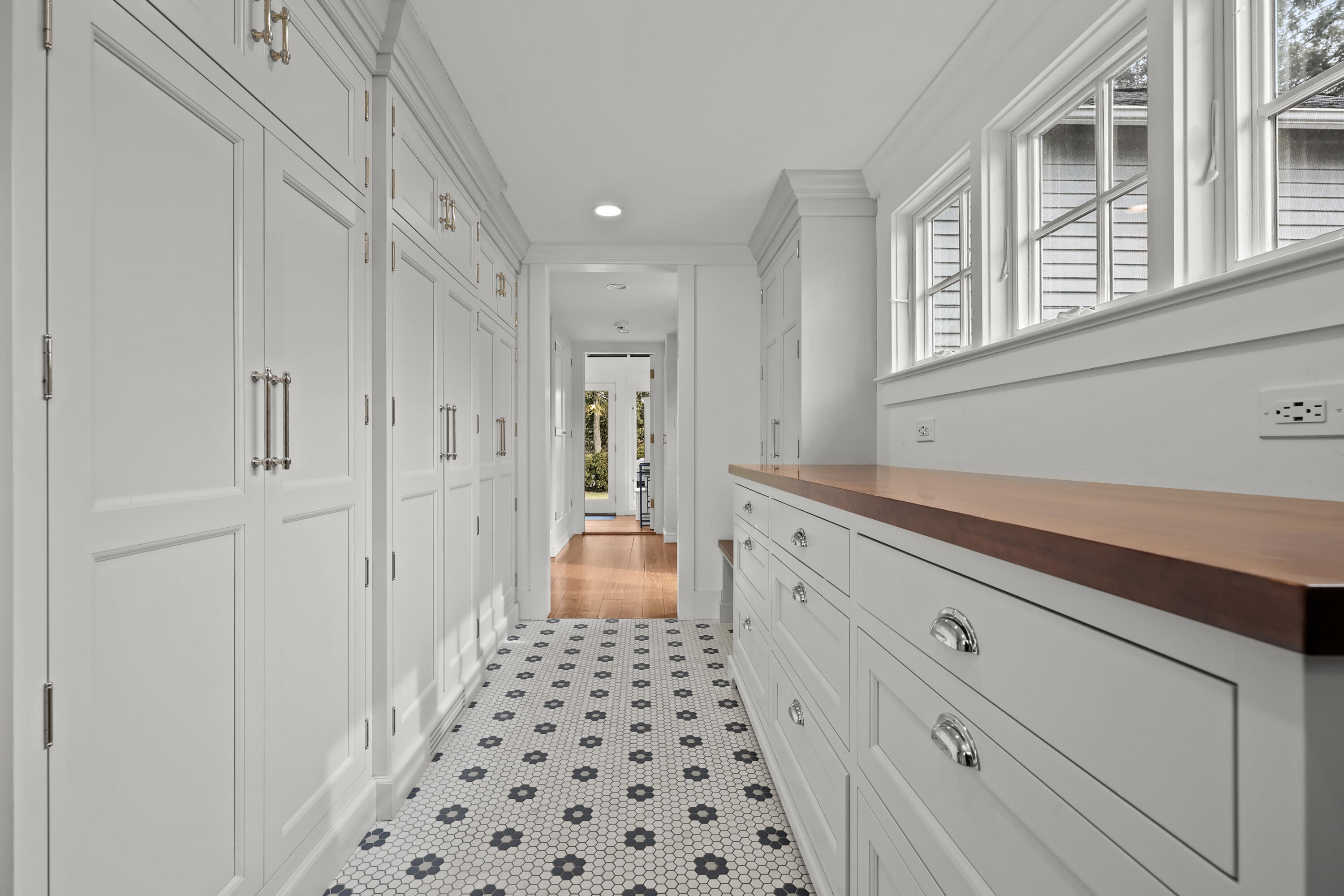 100 Hollow Tree Ridge Road Darien, CT 06820 - Photo 12 of 38 a hallway with white cabinets and window