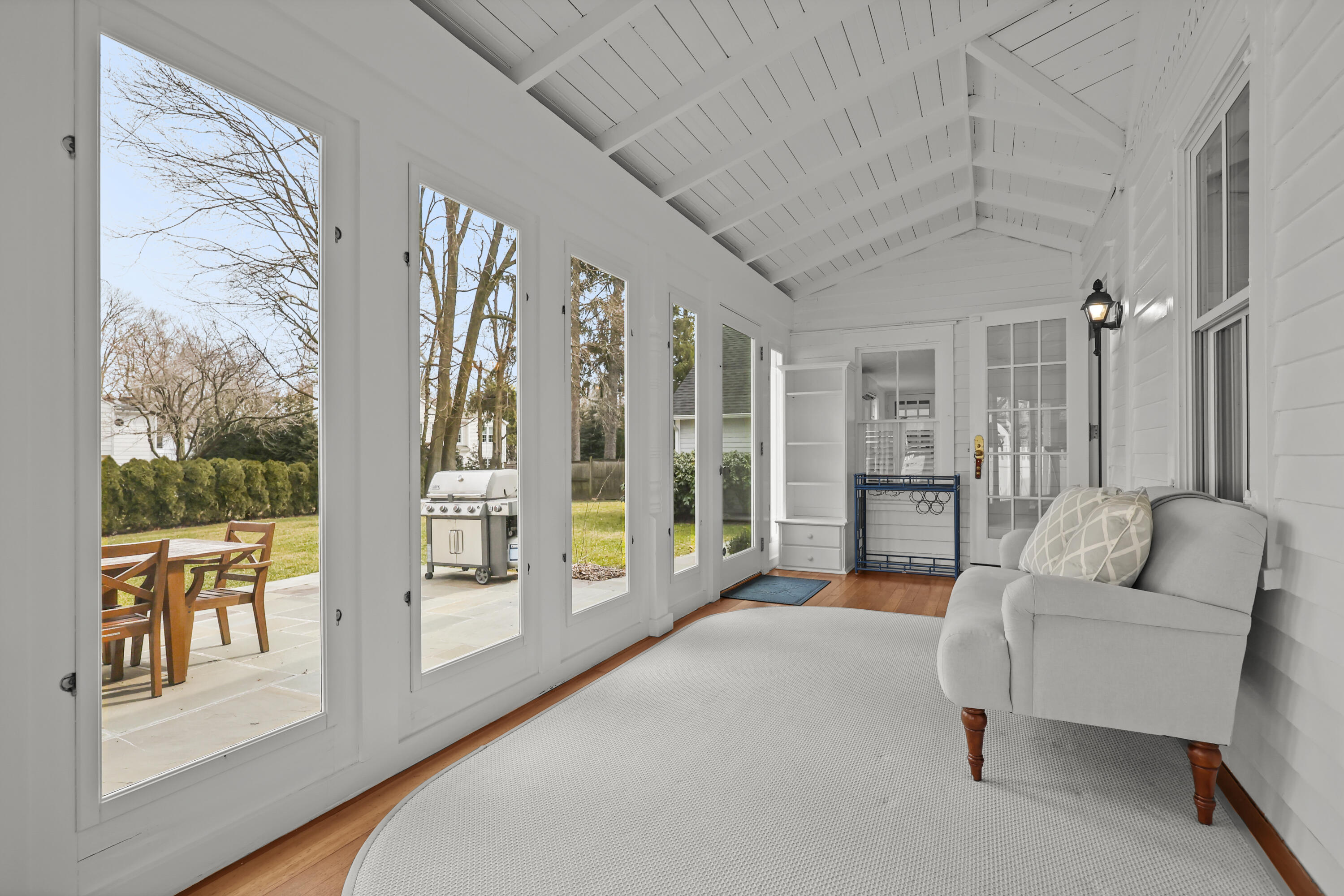 100 Hollow Tree Ridge Road Darien, CT 06820 - Photo 20 of 38 a spacious bedroom with a balcony a bed and a couch