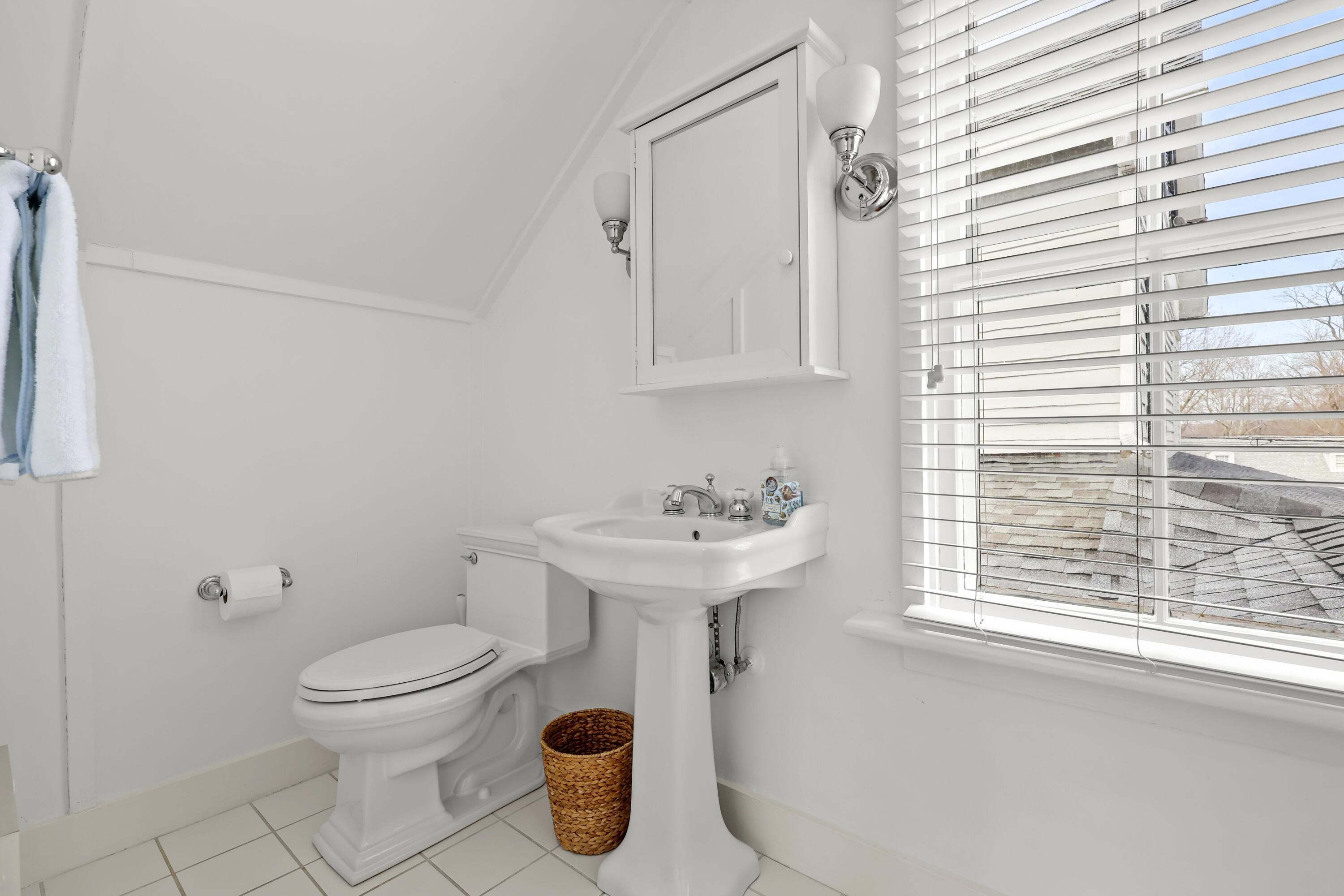 100 Hollow Tree Ridge Road Darien, CT 06820 - Photo 32 of 38 a bathroom with a sink a toilet and a window