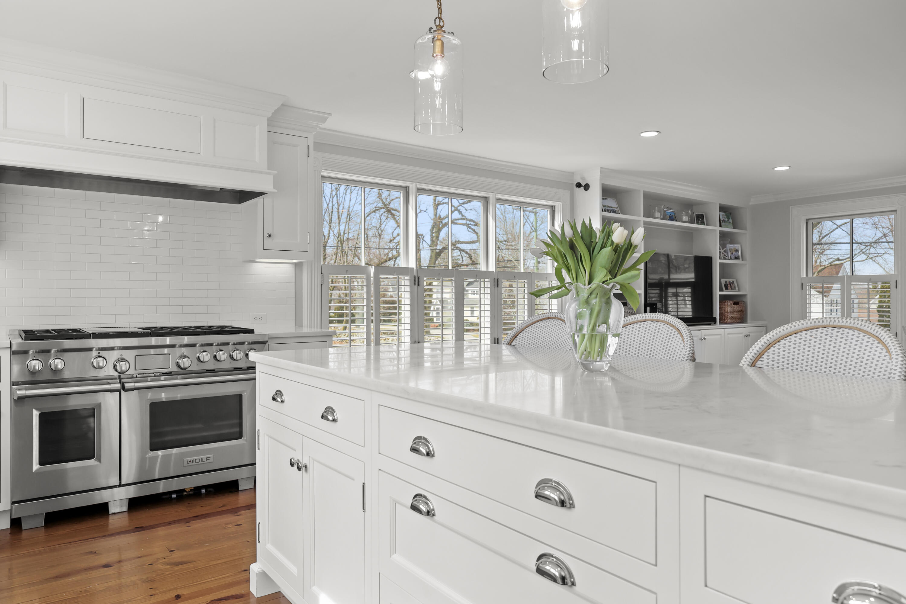 100 Hollow Tree Ridge Road Darien, CT 06820 - Photo 7 of 38 a kitchen with stainless steel appliances white cabinets and wooden floor