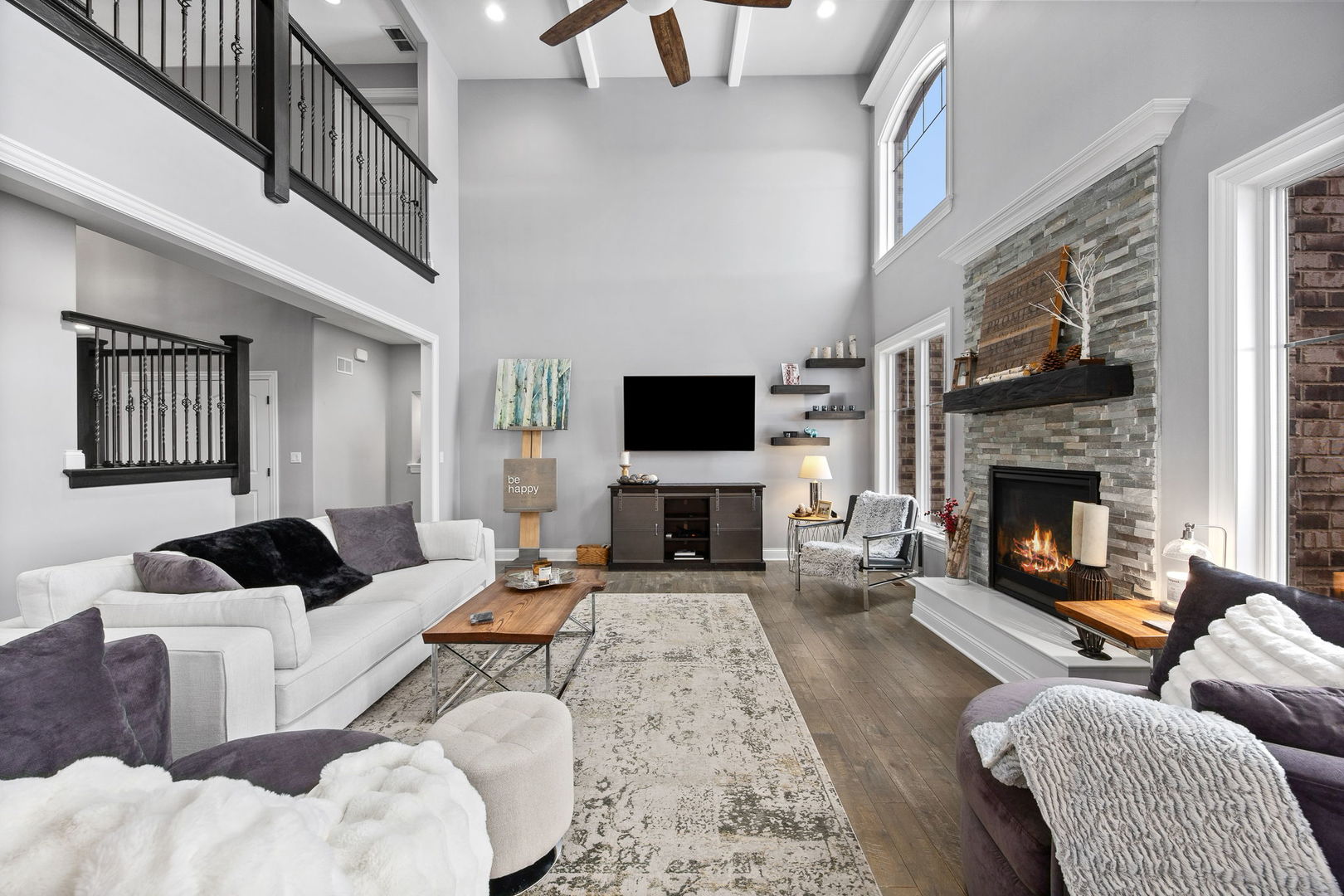 12549 Old Farm Road Manhattan, IL 60442 - Photo 19 of 66 a living room with furniture a flat screen tv and a fireplace