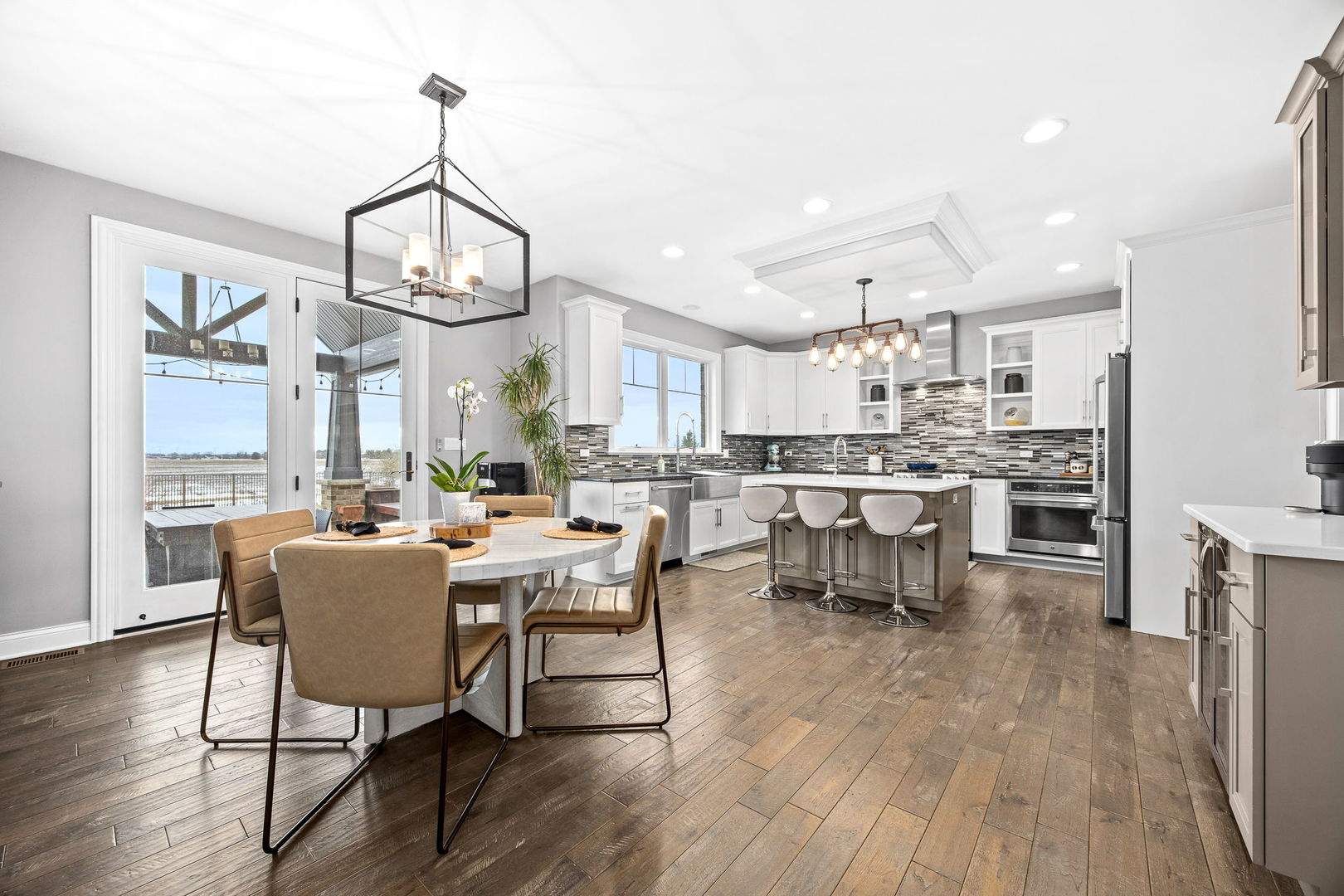 12549 Old Farm Road Manhattan, IL 60442 - Photo 22 of 66 a view of a dining room with furniture a chandelier and wooden floor
