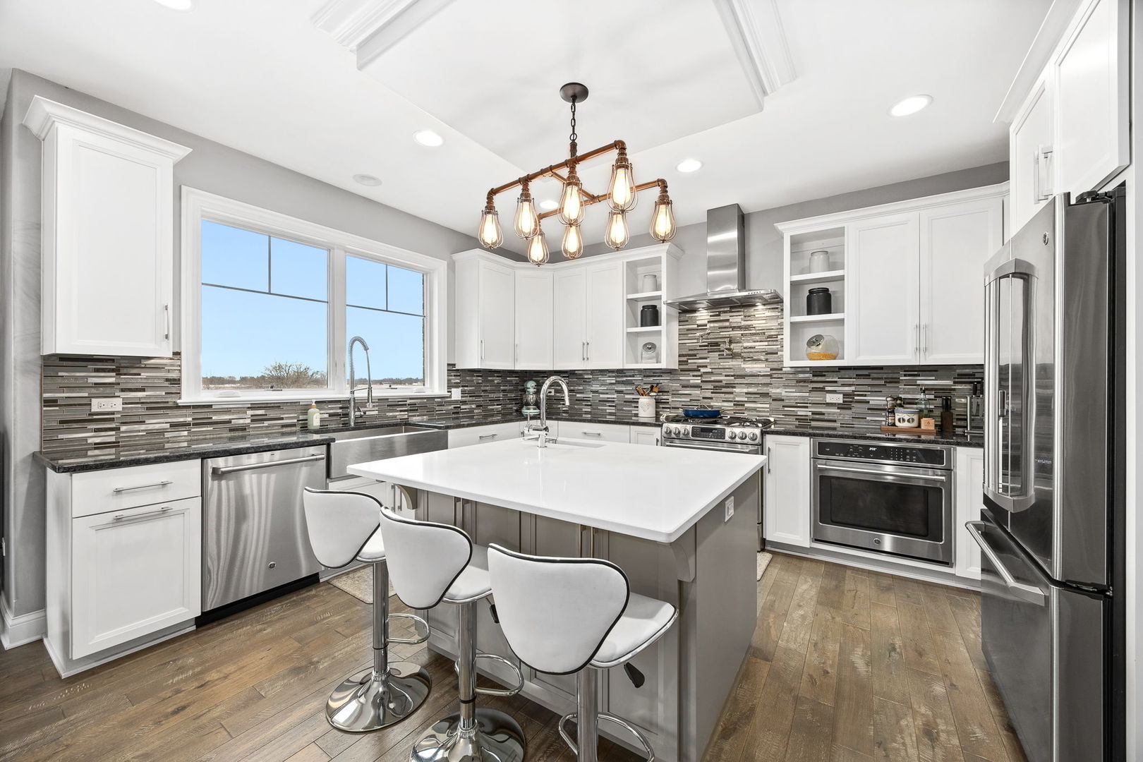 12549 Old Farm Road Manhattan, IL 60442 - Photo 23 of 66 a kitchen with stainless steel appliances granite countertop a sink stove and refrigerator