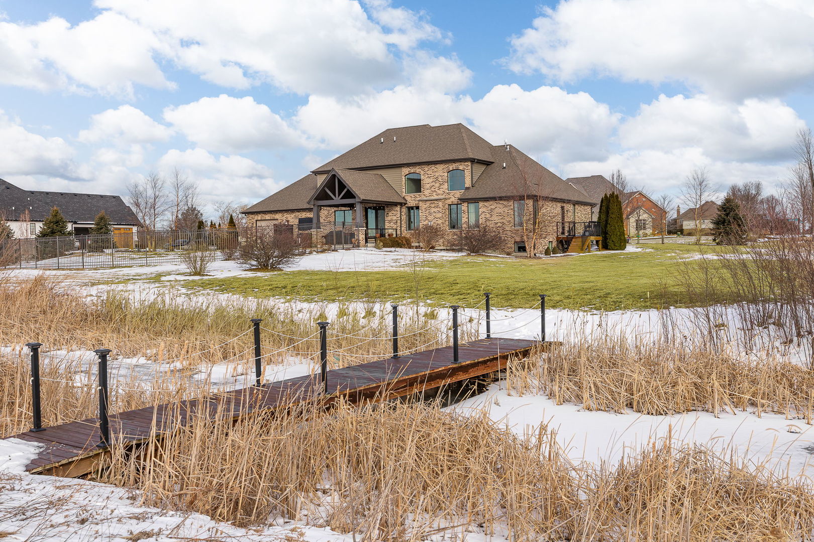 12549 Old Farm Road Manhattan, IL 60442 - Photo 53 of 66 a view of a lake with a house in the background