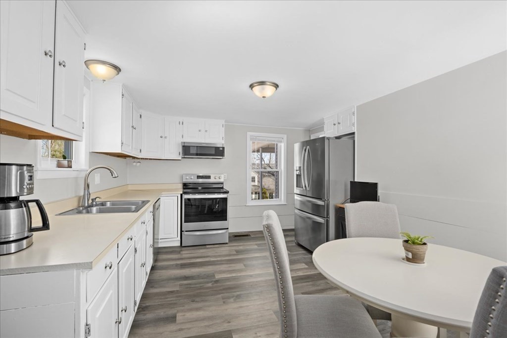 11 Merrill Road Sutton, MA 01590 - Photo 12 of 42 a kitchen with white cabinets and stainless steel appliances