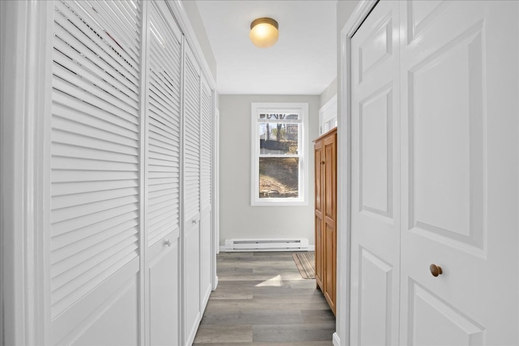 11 Merrill Road Sutton, MA 01590 - Photo 13 of 42 a view of a hallway with windows and wooden floor
