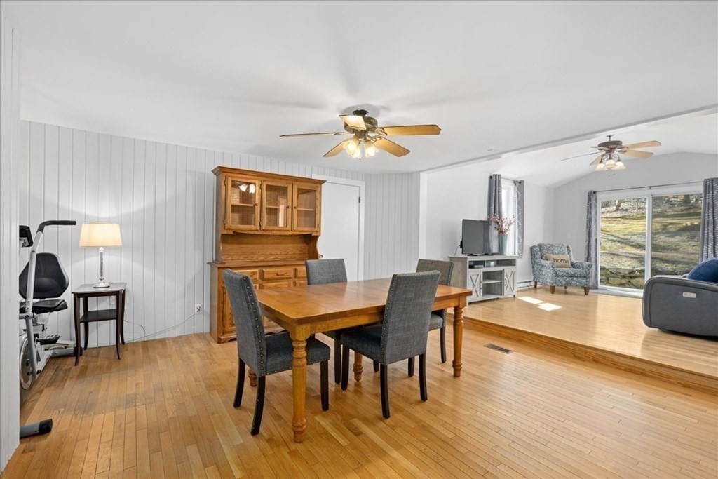 11 Merrill Road Sutton, MA 01590 - Photo 14 of 42 a dining room with furniture a chandelier and wooden floor
