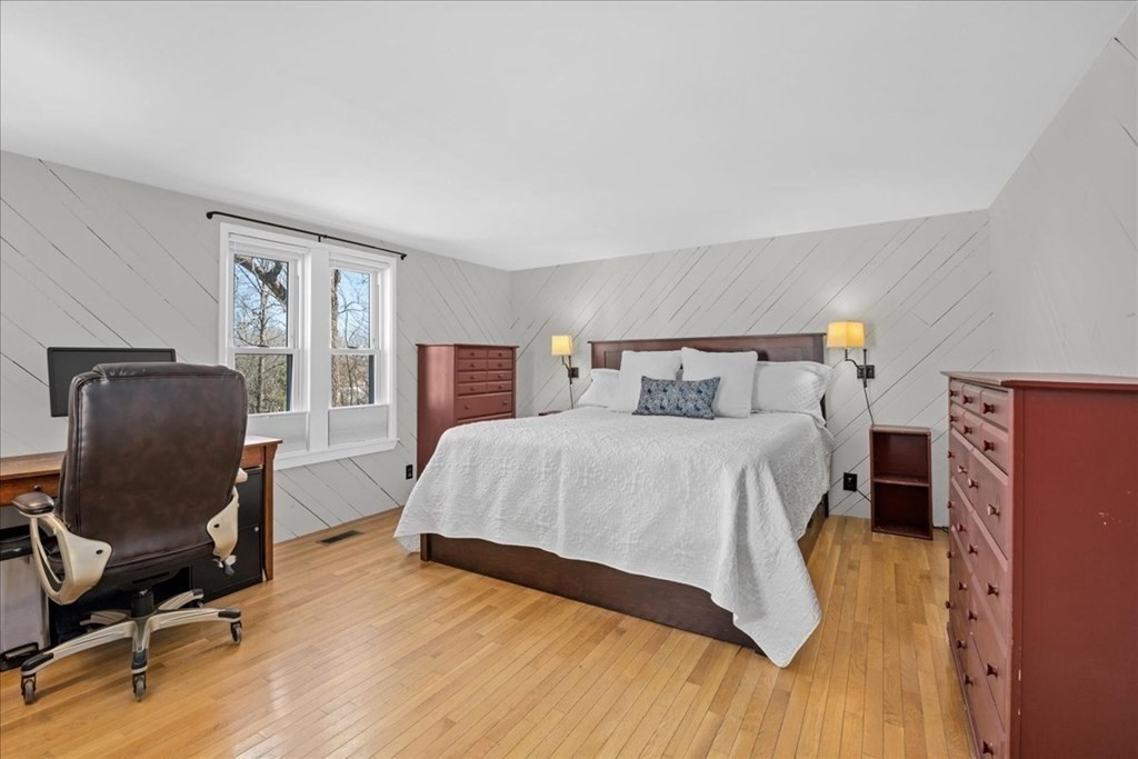 11 Merrill Road Sutton, MA 01590 - Photo 20 of 42 a bedroom with a bed and wooden floor