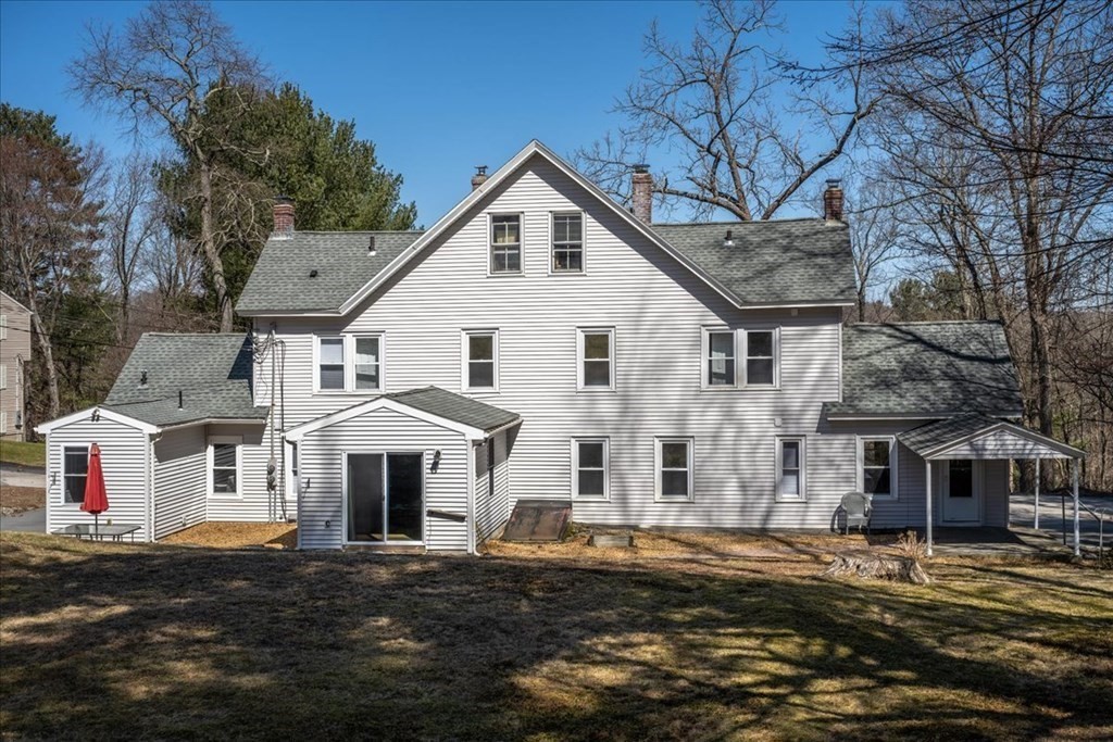 11 Merrill Road Sutton, MA 01590 - Photo 2 of 42 a view of a white house next to a road and yard