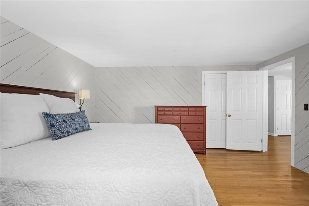 11 Merrill Road Sutton, MA 01590 - Photo 22 of 42 a bedroom with a bed and wooden floor