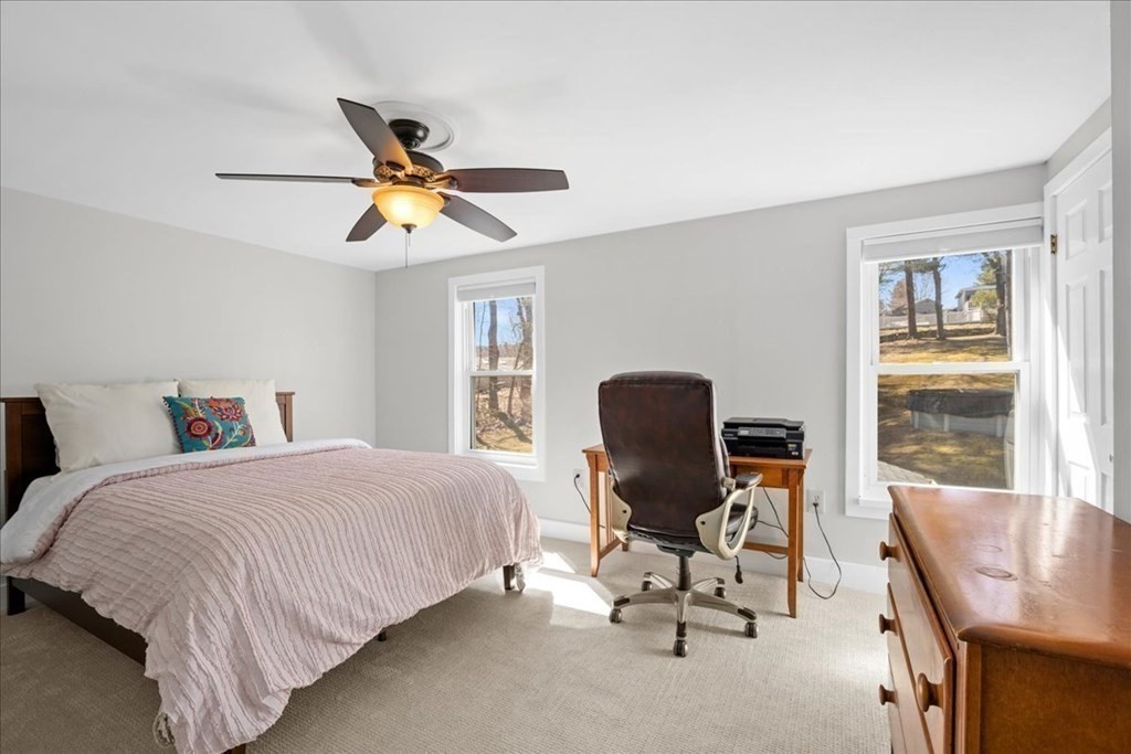 11 Merrill Road Sutton, MA 01590 - Photo 24 of 42 a bedroom with a bed a desk and chair with a potted plant