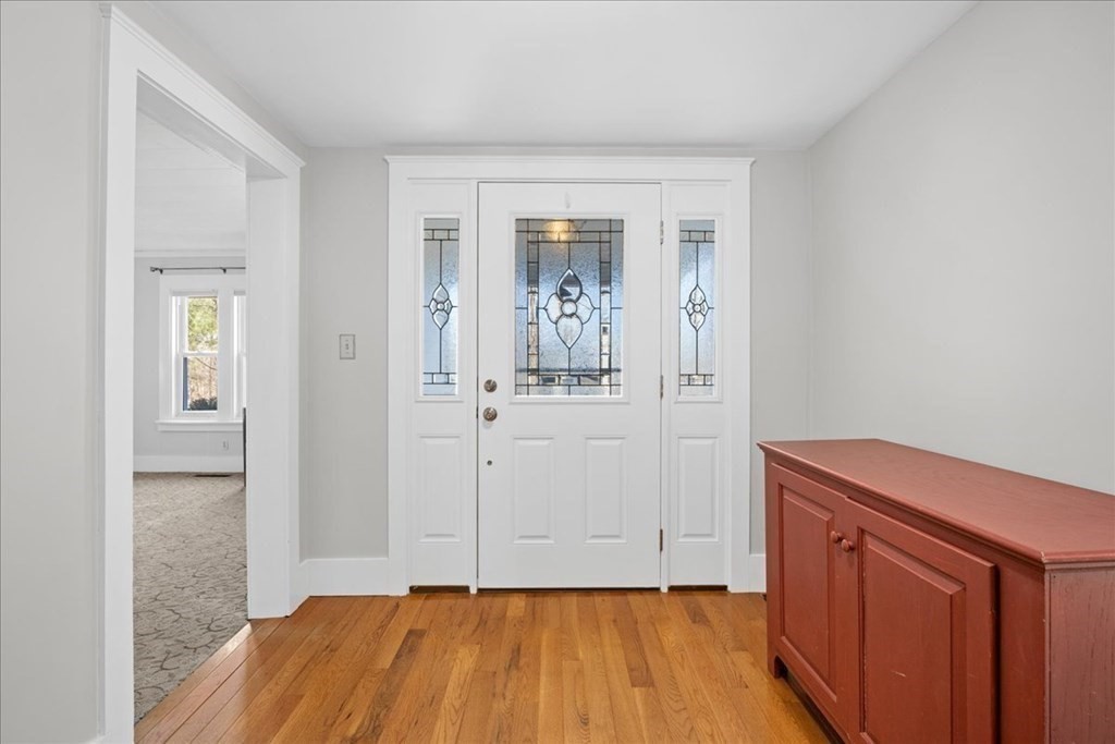 11 Merrill Road Sutton, MA 01590 - Photo 29 of 42 a view of a hallway with wooden floor and a bathroom