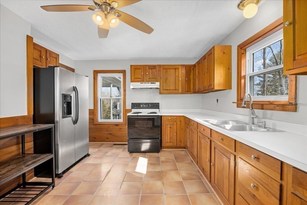 11 Merrill Road Sutton, MA 01590 - Photo 31 of 42 a kitchen with stainless steel appliances granite countertop a refrigerator and a sink