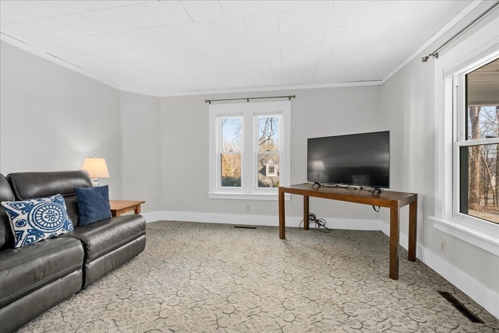 11 Merrill Road Sutton, MA 01590 - Photo 34 of 42 a living room with furniture and a flat screen tv