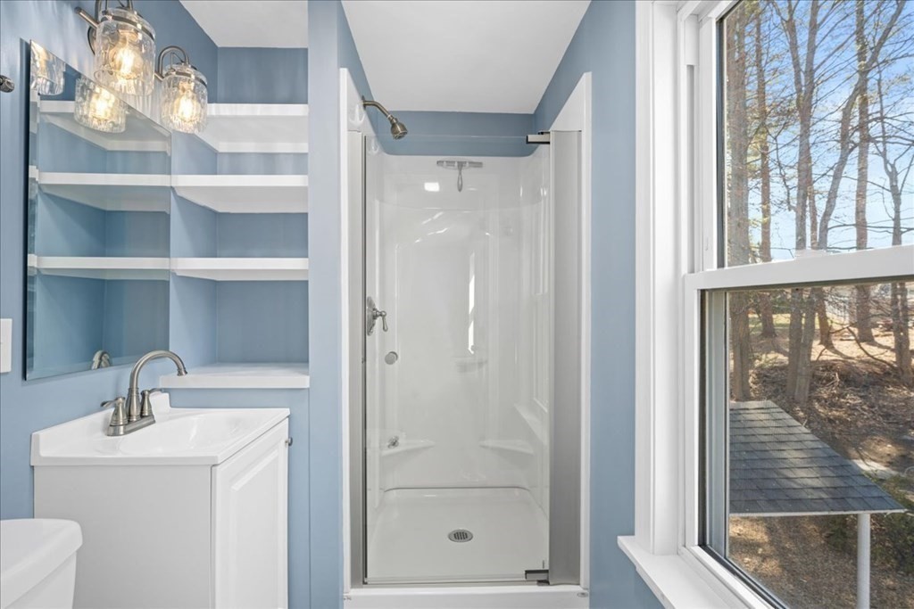 11 Merrill Road Sutton, MA 01590 - Photo 36 of 42 a bathroom with a shower a sink and a window