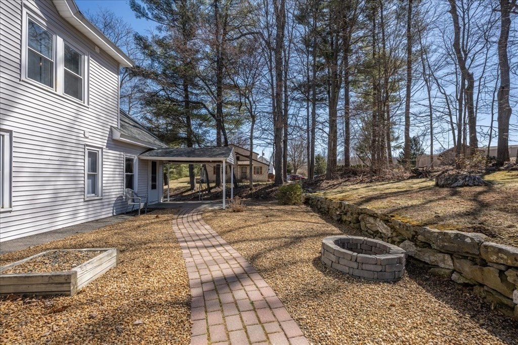 11 Merrill Road Sutton, MA 01590 - Photo 39 of 42 a view of a backyard with table and chairs and potted plants