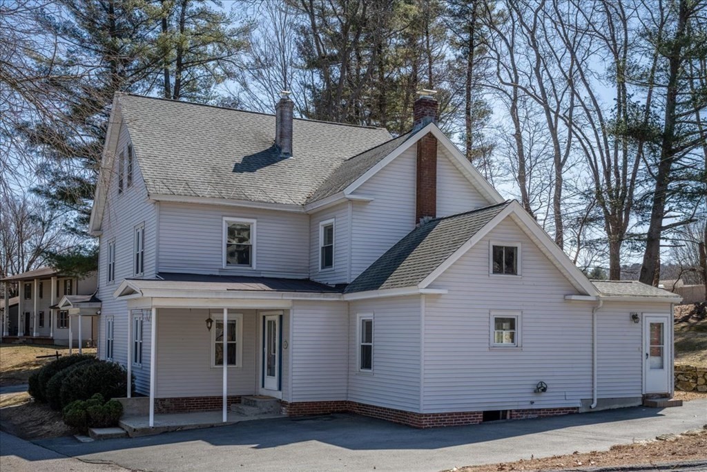 11 Merrill Road Sutton, MA 01590 - Photo 41 of 42 a view of a white house with a large tree