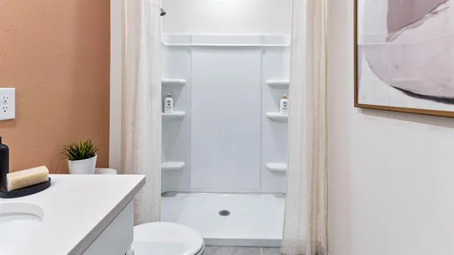 a bathroom with a shower curtain and a window