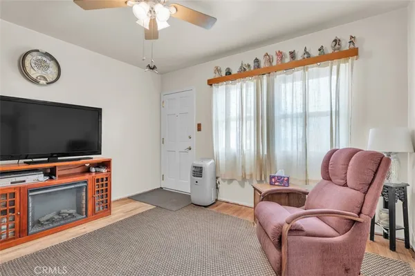 a living room with furniture a flat screen tv and a fireplace