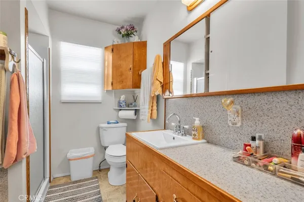 a bathroom with a sink toilet and shower