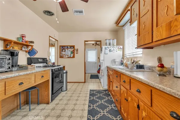 a large kitchen with stainless steel appliances granite countertop a sink and cabinets