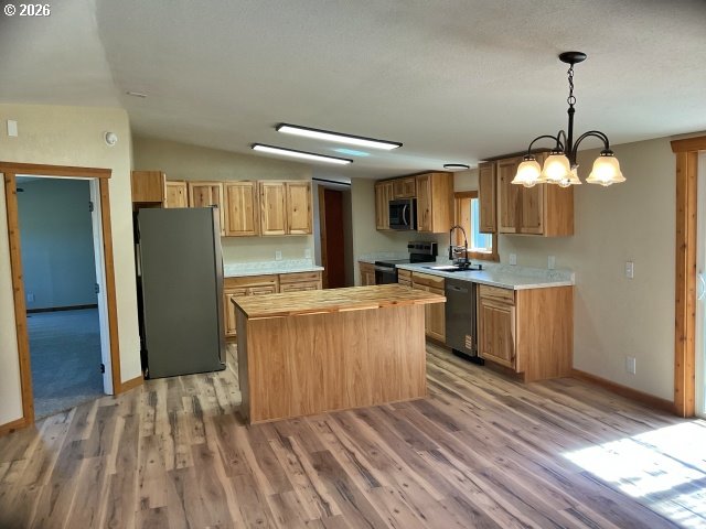 591 Southeast Carroll Street Winston, OR 97496 - Photo 6 of 21 a kitchen with kitchen island stainless steel appliances a sink stove and refrigerator