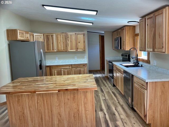 591 Southeast Carroll Street Winston, OR 97496 - Photo 8 of 21 a kitchen with stainless steel appliances granite countertop a refrigerator a stove and a sink with wooden cabinets