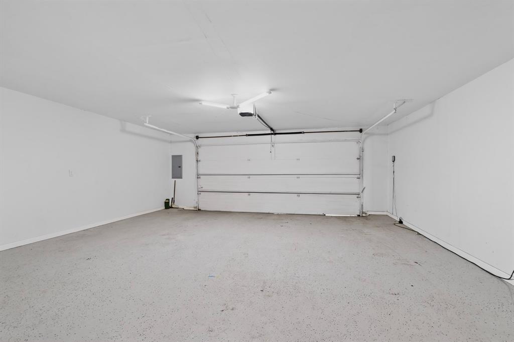 7631 Meadow Road Dallas, TX 75230 - Photo 31 of 40 A spacious garage with ample lighting