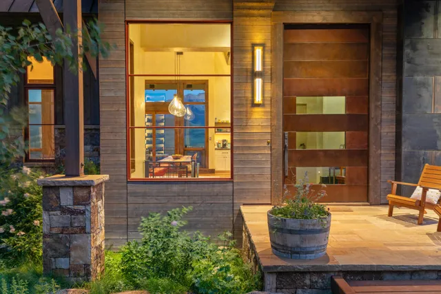 a living room with furniture and a floor to ceiling window