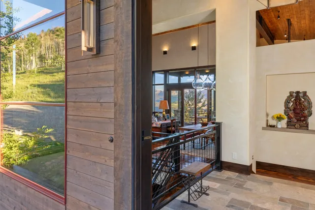 a living room with furniture and a floor to ceiling window