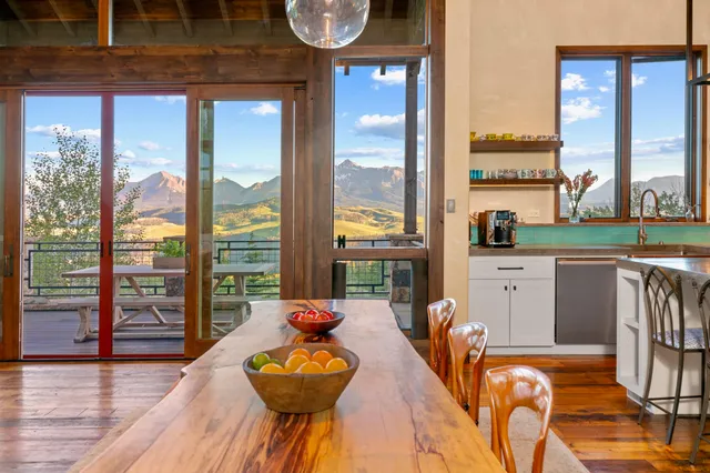 a living room with large window and a flat screen tv