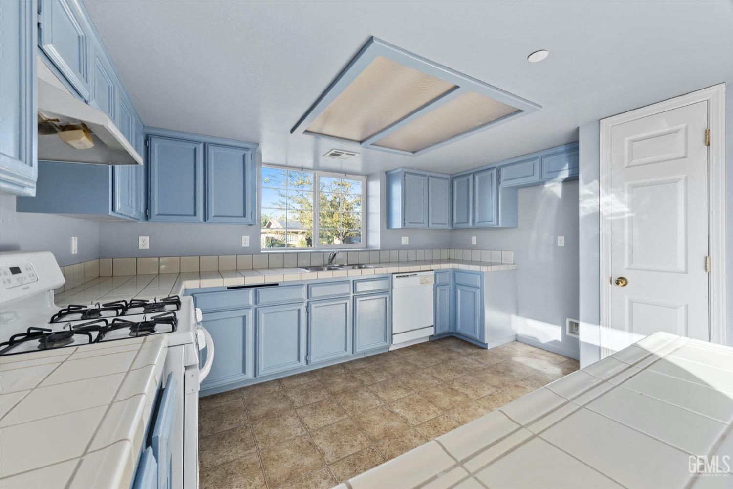 Undisclosed Address Shafter, CA 93263 - Photo 14 of 30 a kitchen with a stove a sink and a refrigerator